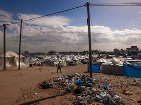 A man walks past makeshift shelters at a camp for displaced Palestinians in Rafah on the southern Gaza Strip on Feb. 15, 2024, amid ongoing battles between Israel and the militant group Hamas.