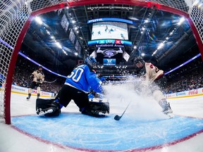 In an image seen from a camera inside the net, Montreal's Catherine Dubois cis seen charging the net front and spraying ice alongside Toronto goaltender Kristen Campbell.