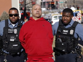 A man is detained by law enforcement following a shooting at Union Station during the Kansas City Chiefs Super Bowl LVIII victory parade on Feb. 14, 2024 in Kansas City, Missouri.