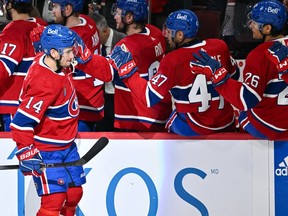 Canadiens' Nick Suzuki (14) celebrates his goal with teammates on the bench during the third period against the Washington Capitals at the Bell Centre on Saturday, Feb. 17, 2024, in Montreal.
