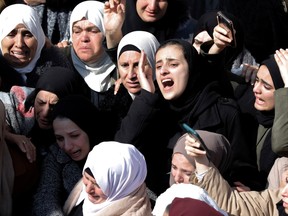 Palestinian women mourn during the funeral procession of Anas Dweikat, 26, in the West Bank town of Rujayb, east of Nablus, on Feb. 19, 2024.