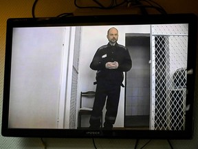 Jailed Russian opposition figure and journalist Vladimir Kara-Murza, who is serving a 25-year sentence for charges including treason over criticism of the Ukraine offensive, appears in court with a video link from his prison for a hearing in the case against inaction of the Investigative Committee of Russia on his poisoning, in Moscow on Feb. 22, 2024.