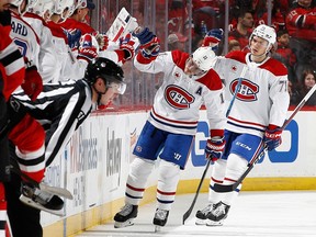 Canadiens' Brendan Gallagher (11) celebrates with the bench after scoring a goal during the second period against the New Jersey Devils at Prudential Center on Saturday, Feb. 24, 2024, in Newark, N.J.