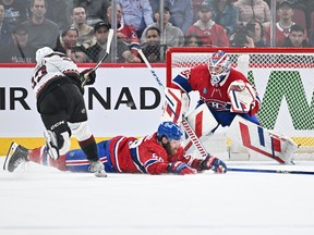Canadiens' David Savard slides across the ice to try to block the shot of Coyotes' Matias Maccelli as Montreal goaltender Sam Montembeault squares to the shooter Tuesday night at the Bell Centre.