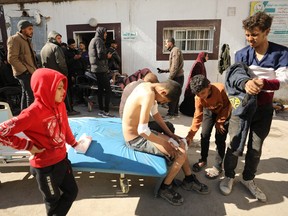 Palestinians receive medical care at Kamal Edwan Hospital in Beit Lahia, in the northern Gaza Strip, on Feb. 29, 2024, after Israeli soldiers allegedly opened fire on Gaza residents who rushed toward trucks loaded with humanitarian aid amid ongoing battles between Israel and the militant Hamas group.