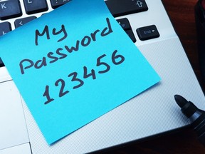 A note on a computer keyboard reads 'My password 123456'