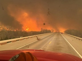 This handout picture courtesy of the Greenville Professional Firefighters Association taken on Tuesday, Feb. 27, 2024, shows a fire truck driving toward the Smokehouse Creek Fire, near Amarillo, in the Texas Panhandle.