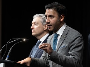 Innovation, Science and Industry Minister François-Philippe Champagne, left, looks on as Justice Minister and Attorney General of Canada Arif Virani responds to a question during a news conference, in Ottawa, Thursday, Feb. 8, 2024.