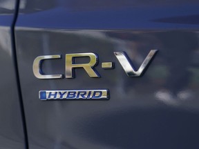 Logos are shown on the exterior of a 2024 Honda CR-V Hybrid in Sunnyvale, Calif., Monday, Dec. 11, 2023.