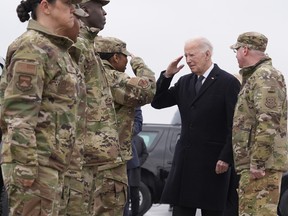 U.S. President Joe Biden greets service members after arriving at Dover Air Force Base, Del., Friday, Feb. 2, 2024.