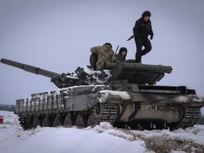 Ukrainian soldiers practise on a tank during military training in Ukraine Wednesday, Dec. 6, 2023.