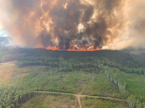 Smoke rises from the Bald Mountain Fire GWF 019 in the Grande Prairie Forest Area near Grande Prairie, Alta., on May 12, 2023.