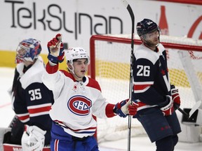 Canadiens' Juraj Slafkovsky celebrates one of the two third-period goals he scored Tuesday night in Washington as Capitals goaltender Darcy Kuemper and winger Nic Dowd look on.