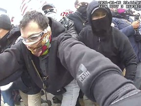 This image from police body-worn camera video, and contained in the Justice Department's sentencing memorandum, shows Marc Bru, at the U.S. Capitol on Jan. 6, 2021, in Washington. Bru, who stormed the U.S. Capitol with fellow Proud Boys extremist group members, has been sentenced to six years in prison. (Department of Justice via AP)