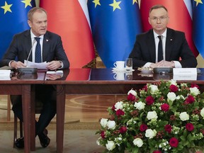 Poland's Prime Minister Donald Tusk, left, and President Andrzej Duda attend a meeting of the Cabinet Council, a consultation format between the president and the government in Warsaw.