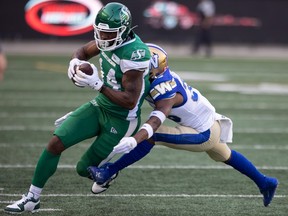 Roughriders receiver Tevin Jones is seen last year with the ball in his hands atempting to elude a Bombers defender last season.