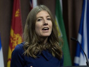 NDP MP for Victoria Laurel Collins makes her way to the podium to speak during a news conference, in Ottawa, Tuesday, Dec. 5, 2023.