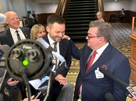 Parti Québécois leader Paul St-Pierre Plamondon smiles as former Montreal mayor Denis Coderre rests his hand on his shoulder at the National Assembly in front of reporters..