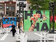 A woman walks past a series of signs saying "Ha ha"