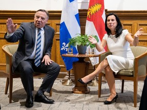 Coalition Avenir Quebec Leader Francois Legault and Montreal mayor Valerie Plante chat prior to a meeting in Montreal, Que., Tuesday, Sept. 13, 2022. THE CANADIAN PRESS/Paul Chiasson