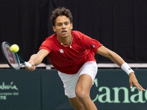 Gabriel Diallo of Canada hits a return to Kwon Soonwoo of South Korea during the first singles match of the Davis Cup tennis qualifiers in Montreal on Friday, Feb. 2, 2024.