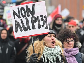 People take part in a demonstration against the Quebec government's housing Bill 31 in Montreal on Saturday, Feb. 3, 2024.