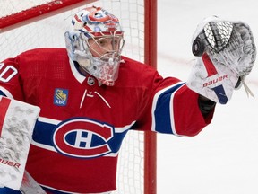 A close-up of Canadiens' Cayden Primeau making a glove save.