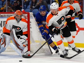 Sabres' Filip Cederqvist is seen hounding Flyers defenceman Ronnie Attard behind the Flyers goal during pre-season game in 2022.