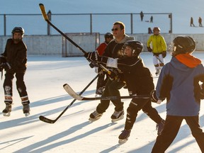 Playing hockey on an outdoor rink on a winter day.