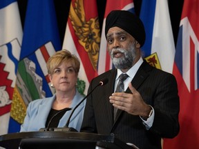 Manitoba Transport Minister Lisa Naylor listens as Minister of Emergency Preparedness Harjit Sajjan responds to a question during a news conference following meetings with provincial partners, Wednesday, Feb. 21, 2024 in Ottawa.
