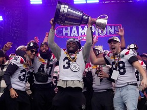 Running-back William Stanback holds up the Grey Cup during the Alouettes' celebration in Montreal last November.