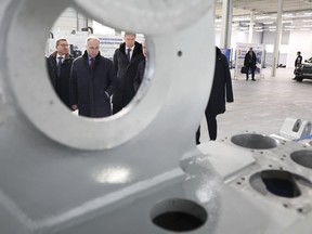 Russian President Vladimir Putin looks at productions of the Chelyabinsk Forge-and-Press Plant in Chelyabinsk, Russia, Friday, Feb. 16, 2024.