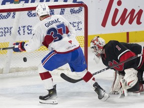 Rocket centre Brandon Gignac is seen from behind as the puck enters a wide-open net behind Comets goaltender Isaac Poulter.