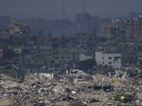 Destroyed buildings stand in the Gaza Strip as seen from southern Israel, Thursday, Feb. 15, 2024.