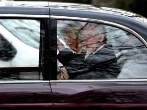 King Charles III waves as he and Queen Camilla leave Clarence House by car in London, Tuesday, Feb. 6, 2024.