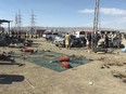 Security officials examine the scene of a bomb blast in Khanozai, Pashin, a district of Pakistan's Baluchistan province, Wednesday, Feb. 7, 2024.