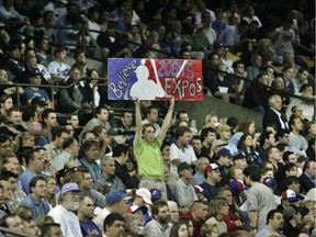 A fan holds up a sign reading 'Believe 2004-5 Expos'