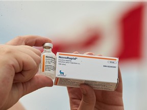 Allison Nimlos, of Minnesota, holds up her American bottle of NovoLog insulin and a Canadian box of NovoRapid, which she picked up at a Walmart pharmacy in London, Ont., Saturday, June 29, 2019.