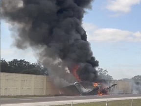 Smoke and fire fills the air after an airplane crashed on Interstate 75, Friday, Feb. 10, 2024, near Naples, Fla.