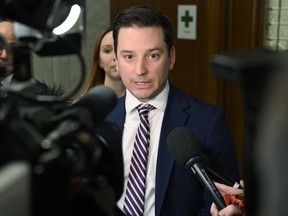 Quebec Justice Minister Simon Jolin-Barrette responds to reporters' questions at the Legislature in Quebec City, Tuesday, Jan. 30, 2024.