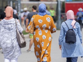 Women wear hijabs as they walk in the Old Port in Montreal, Thursday, August 11, 2022. The Quebec Court of Appeal will rule on the constitutionality of the province's secularism law, better known as Bill 21, in a hotly anticipated ruling today.