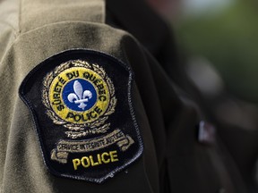 A provincial police emblem is seen on an officer's uniform in Montreal on Aug. 22, 2023.