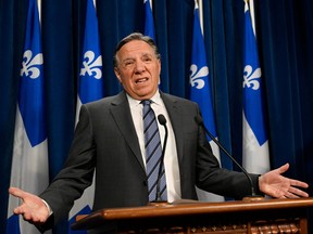 Quebec Premier François Legault gestures as he announces his decision to stop accepting private funding on Thursday, Feb. 1, 2024, at the legislature in Quebec City.