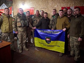 In this photo provided by the Ukrainian Presidential Press Office, Ukrainian President Volodymyr Zelenskyy, centre, poses for a photo with soldiers during his visit to the front line city of Kupiansk, Kharkiv region, Ukraine, Monday, Feb. 19, 2024.
