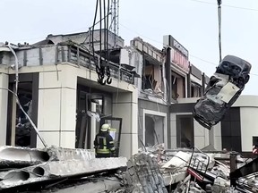 In this photo taken from video released by Russian Emergency Ministry Press Service on Saturday, Feb. 3, 2024, Russian Emergency Ministry employees work at the side of a collapsed bakery after an attack of Ukrainian troops, that Russian officials in Luhansk said was conducted by Ukrainian forces, in Lysychansk, Russian-controlled Luhansk region, eastern Ukraine. According to the Russian Emergency Ministry, five people were found dead under the rubble. Eight people were injured and there might be dozens of civilians under the debris, Moscow-installed authorities said. Search and rescue efforts continue.