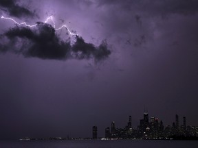 Lightning strikes above downtown Chicago as a storm moves over Lake Michigan following two days of unseasonably warm weather, Tuesday, Feb. 27, 2024.