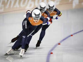 Joy Beune, left to right, Irene Schouten, and Marijke Groenewoud race to first place during the women's team pursuit event at the ISU World speedskating Championships in Calgary on Friday, Feb. 16, 2024.