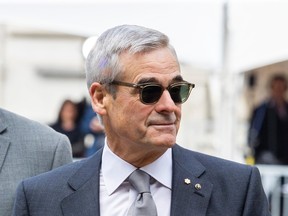 Pierre Boivin is seen in a suit and wearing sunglasses.