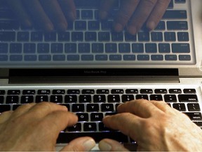 In this Feb. 27, 2013, file photo illustration, hands type on a computer keyboard in Los Angeles.