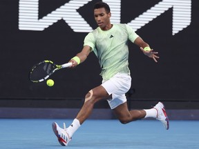 Félix Auger-Aliassime of Montreal plays a forehand return to Daniil Medvedev of Russia at the Australian Open tennis championships at Melbourne Park, Melbourne, Australia, on Saturday, Jan. 20, 2024. Auger-Aliassime advanced to the semifinals of the Open Sud de France tennis tournament with a convincing 7-5, 6-1 win over French wild-card Harold Mayot on Friday, Jan. 2, 2024.